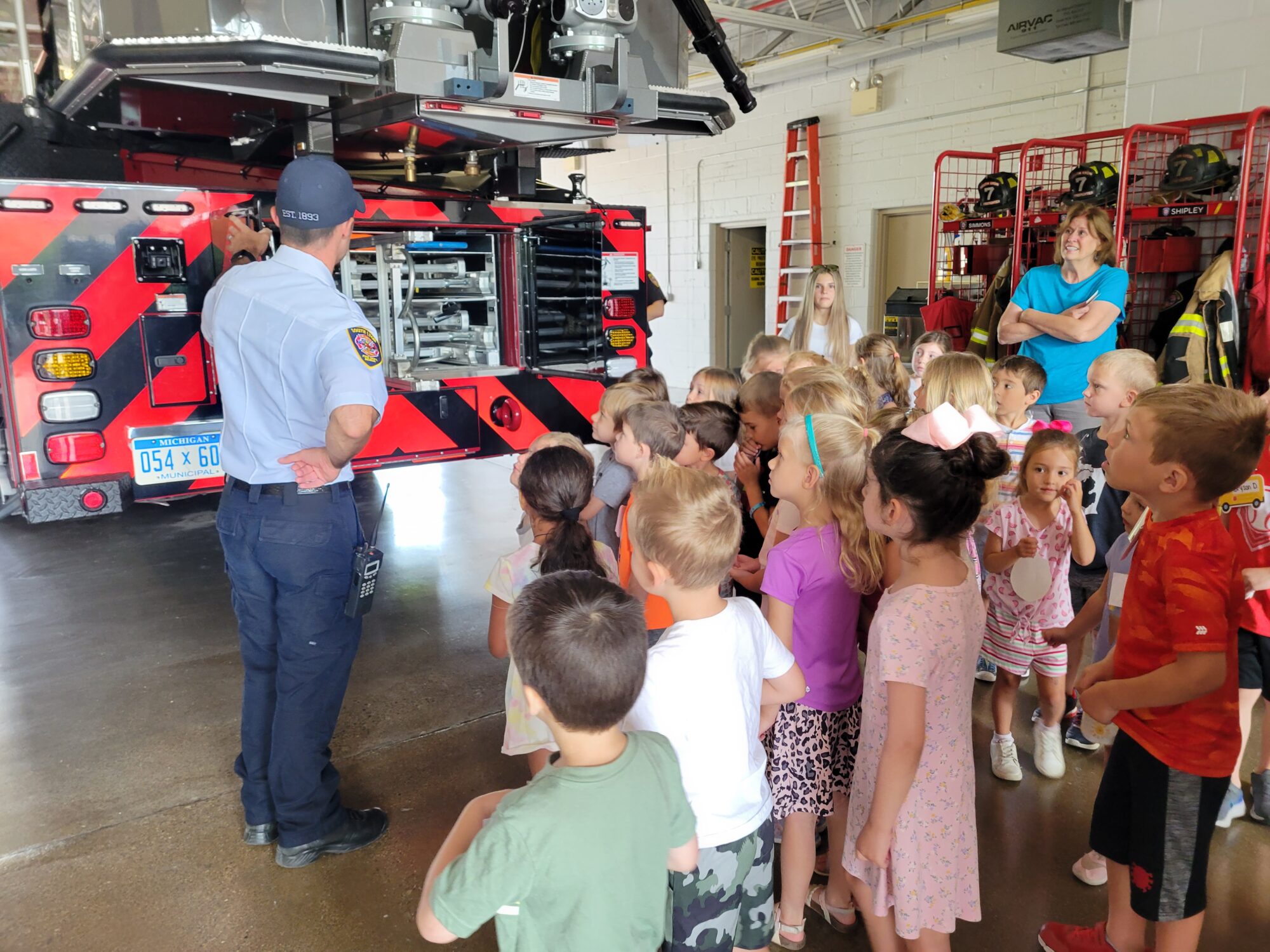 firefighter with kids in firehouse