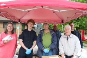 People under a red canopy smiling