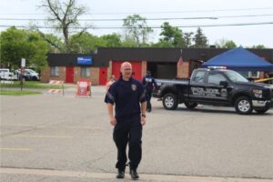 Police officer walking near parked police truck