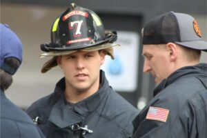 Firefighter in conversation with colleagues