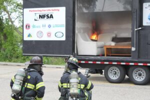 Firefighters observing controlled fire in trailer
