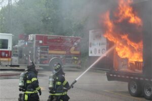 Firefighters extinguishing a blaze in a trailer