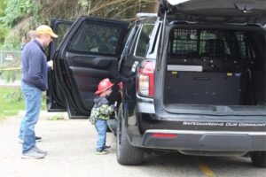 Child exploring police vehicle at community event
